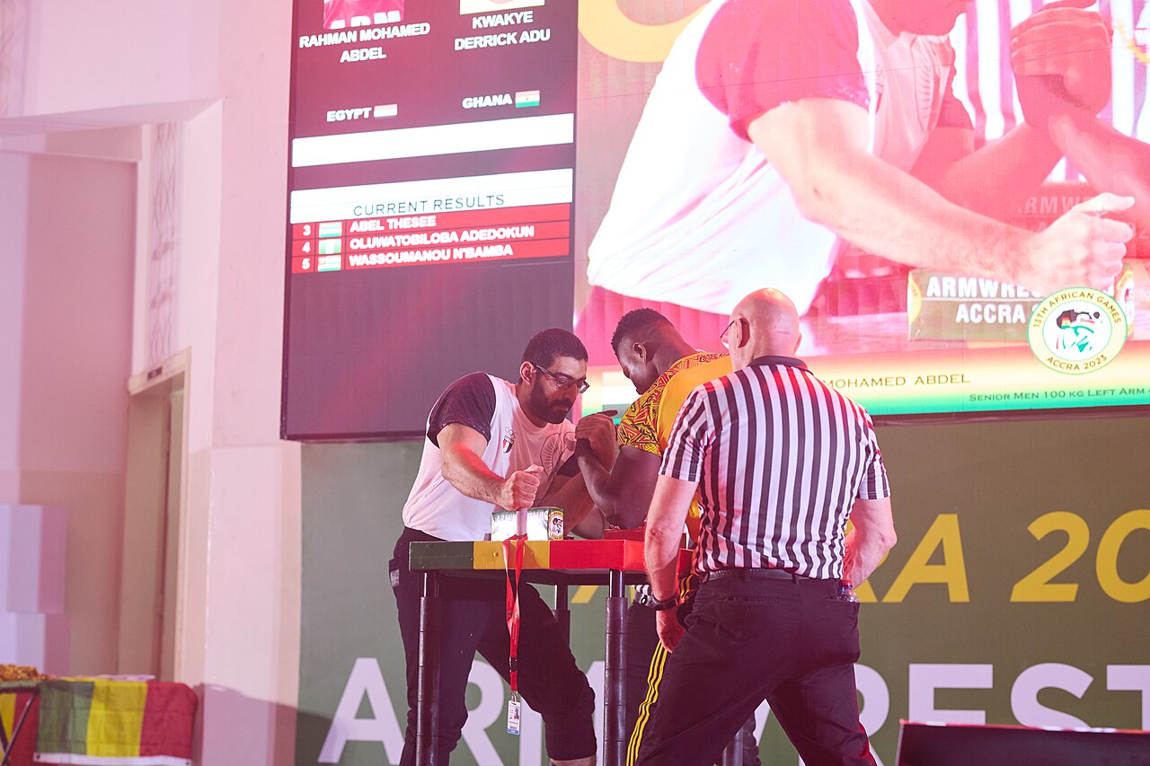 Both referees check the elbows